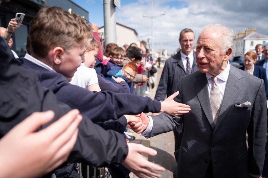 Britain's King Charles III, right, meets well-wishers outside The Pantry Foodbank in Donard Methodist Church, Newcastle, Northern Ireland, Wednesday, May 20, 2026.
