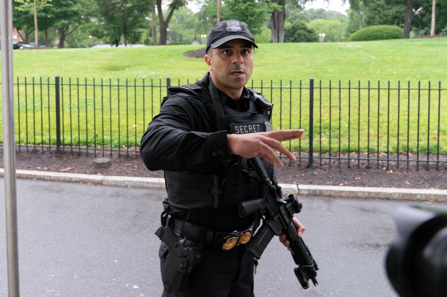 A member of the Secret Service stops journalist from leaving the White House, Saturday, May 23, 2026, in Washington.