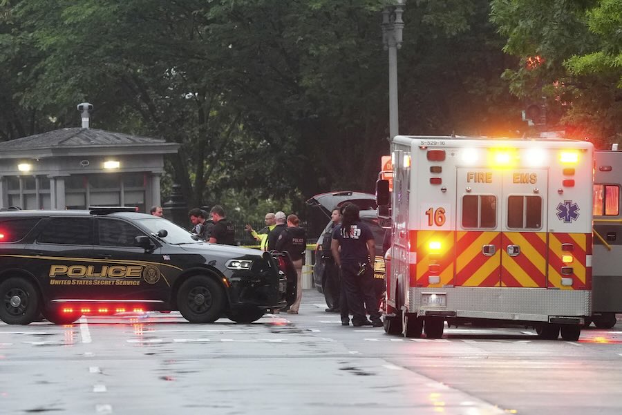 Police and members of the Secret Service stand near an EMS truck after blocking streets around the White House, Saturday, May 23, 2026, in Washington.