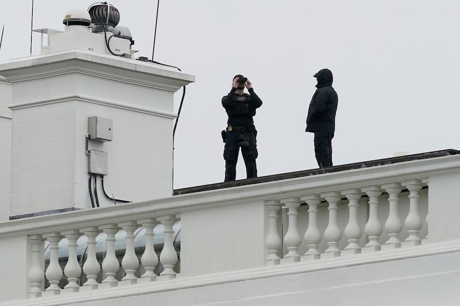 U.S. Secret Service Police observe from the roof of the White House, Saturday, May 23, 2026, in Washington, after reports of shots fired near the White House.