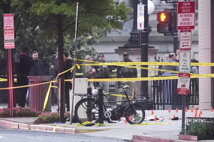 Evidence markers are seen on a crime scene after police responded to reports of shots fired near the White House, Saturday, May 23, 2026, in Washington.