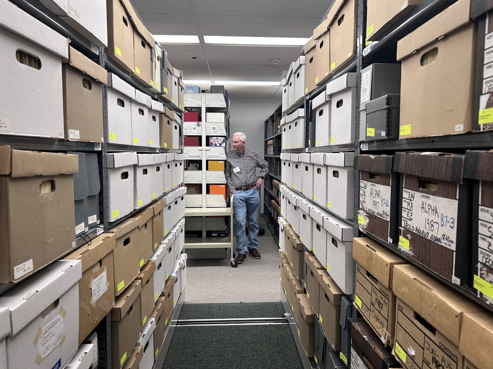 Longtime Idaho journalist and former president of Idaho Businesses for Education Rod Gramer stands among the reference materials in the Cecil D. Andrus Papers in the Special Collection and Archives at the Albertsons Library at Boise State University. The collection includes 40 years’ worth of correspondence, memoranda, press releases, calendars, reports and materials documenting Andrus’ service as U.S. secretary of the Interior and also personal items pertaining to his five campaigns for governor and the Idaho Legislature. | Christina Lords, Idaho Capital Sun