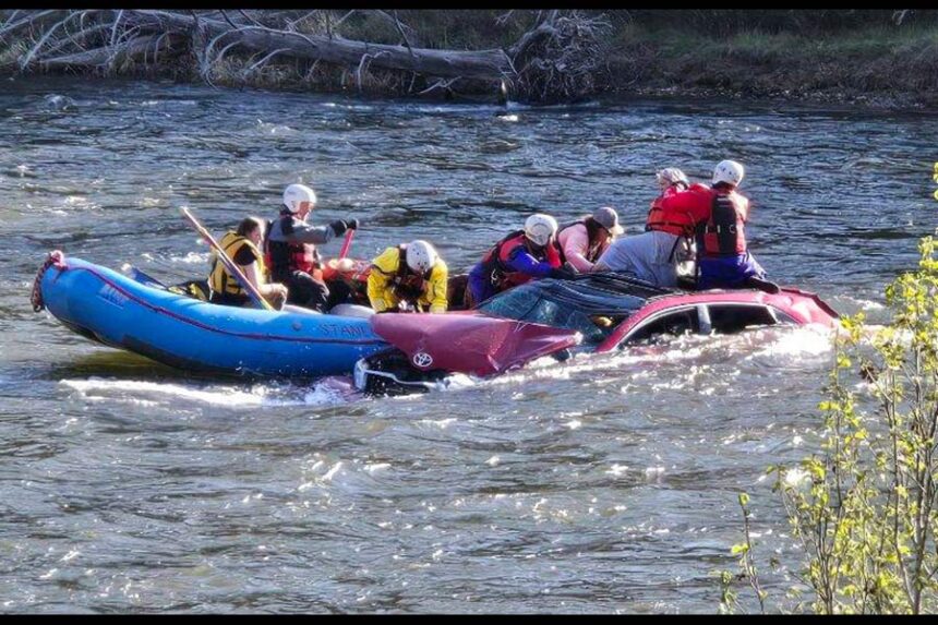 Deputies work to rescue three people after their car ended up in the Salmon River near Stanley by Mormon Bend. | Custer County Sheriff's Office