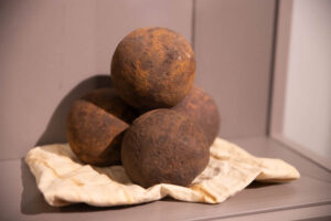 Six-pound iron cannonballs are seen inside the Museum of Idaho. These were found near Pekin, North Carolina. They may have been lost in 1781 while being transported from the Battle of Guilford Court House to a supply depot that stored weapons for General Nathanael Greene. | Cody Roberts, EastIdahoNews.com