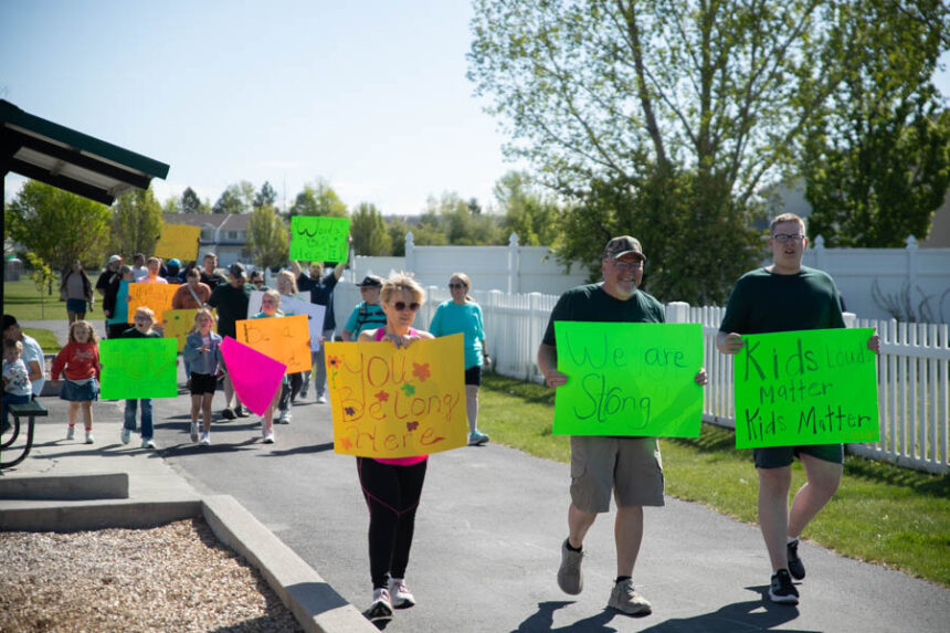 Community members walk around Eagle Point Park in Ammon Saturday with signs for an anti-bullying walk. | Cody Roberts, EastIdahoNews.com