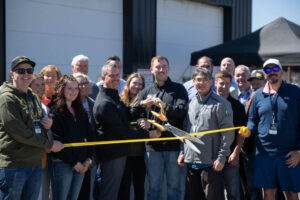 Shane Ricks, Caleb Woolley and others hold a ribbon cutting ceremony for a new auto repair shop in Idaho Falls on Friday. | Cody Roberts, EastIdahoNews.com