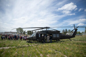 American Heritage Charter School students line up to check out a Black Hawk helicopter. | Cody Roberts, EastIdahoNews.com