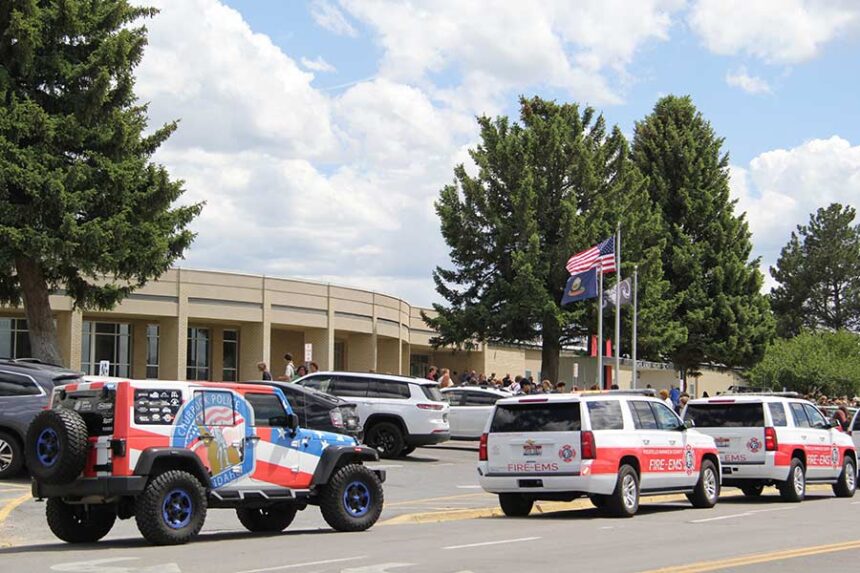 Emergency vehicles parked in front of Highland High School.