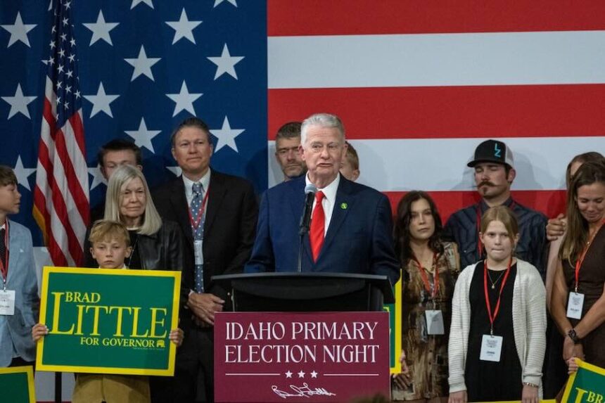 Idaho Gov. Brad Little, surrounded by friends and family, speaks to supporters at a May 19, 2026, primary election party at the Grove Hotel in Boise.
