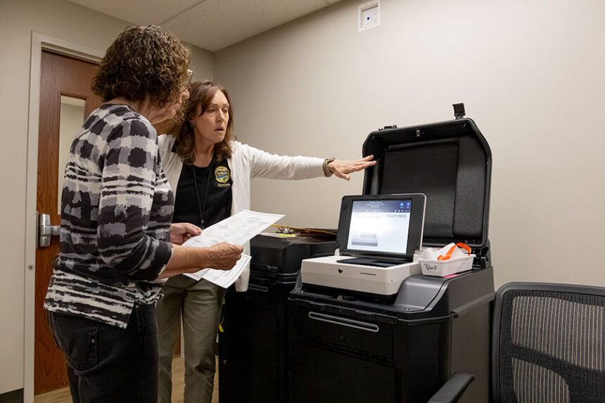 Cathy Dabell Election Administrator for Jefferson County, explaining to Kathy Field, a Republican representative, how the new machines work when submitting a ballot. | Daniel V. Ramirez, EastIdahoNews.com