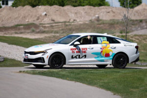 A Kia sedan parades around Heritage Park in an event kicking off the 35th annual duck race in Idaho Falls. The Kia will be one of the prizes of this year's race. | Cody Roberts, EastIdahoNews.com