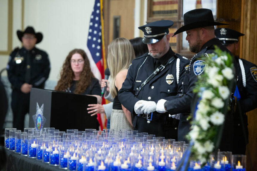 Local law enforcement officers place candles for fallen Idaho officers during a memorial service on Friday. | Cody Roberts, EastIdahoNews.com