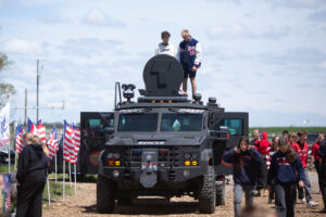 Students stand atop an armored police vehicle outside of American Heritage Charter School on Monday. | Cody Roberts, EastIdahoNews.com