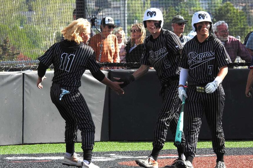 Highland baseball Ty Dixon (11) and Cooper Colonel (7) greet Marshall Glenn (2) at the plate