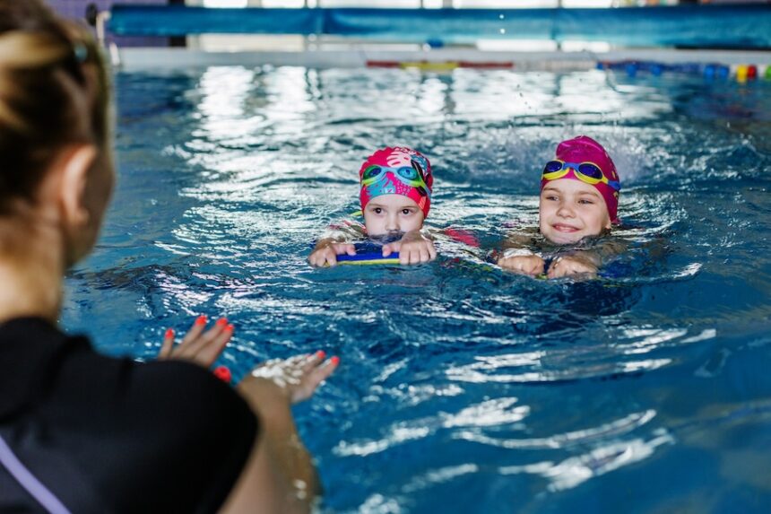 children learn to swim with board in pool under gu 2026 03 20 04 23 35 utc