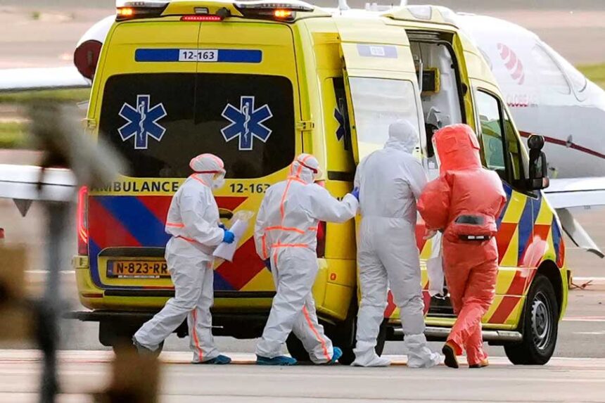 Medics escort a patient, second right, evacuated from the MV Hondius cruise ship with suspected hantavirus infection, to an ambulance after being flown on Wednesday, May 6, 2026, to Schiphol airport, Amsterdam, Netherlands. | Peter Dejong/AP via CNN Newsource