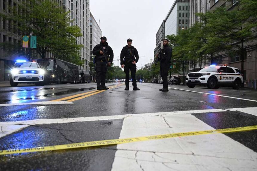 Police vehicles stand on a blocked street near the White House after agents shot and killed a man they say opened fire on them at a checkpoint.