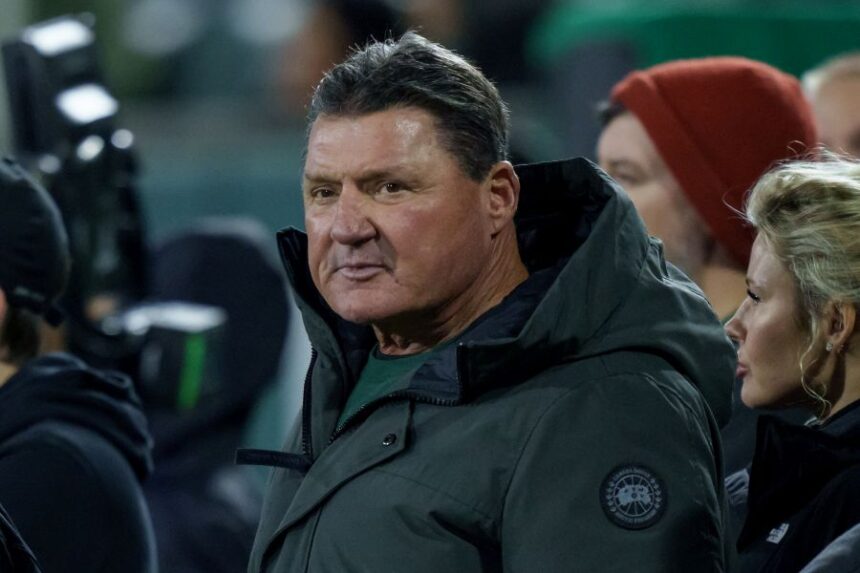FILE - Former LSU head coach Ed Orgeron and Brandy Nicole, right, watch the American Conference championship NCAA college football game against North Texas in New Orleans, on Dec. 5, 2025. (AP Photo/Matthew Hinton, File)