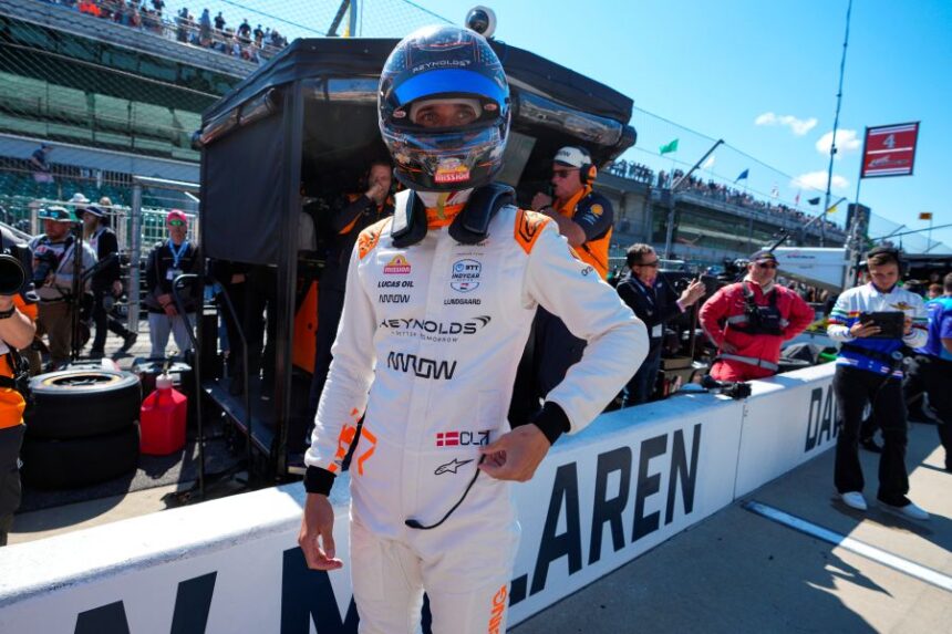 FILE - Christian Lundgaard, of Denmark, waits to climb into his car before the start practice for the Indianapolis 500 auto race at Indianapolis Motor Speedway in Indianapolis, May 23, 2025. (AP Photo/Michael Conroy, File)