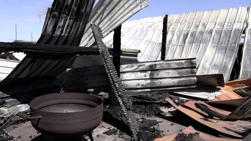 Charred debris left behind after a wildfire burned through the area.