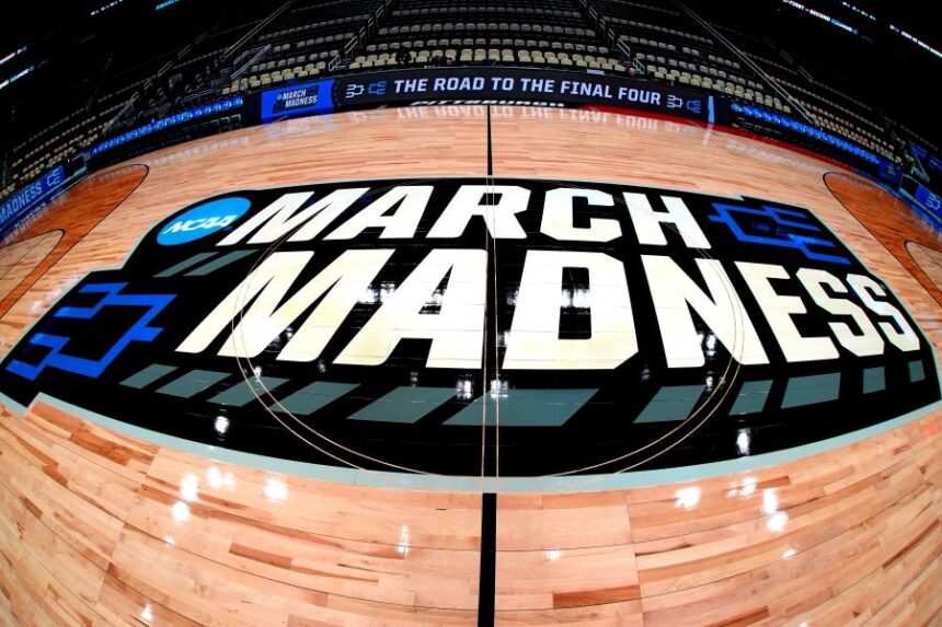 FILE - March Madness logo sis displayed at center court during the opening rounds of the NCAA college basketball tournament in Pittsburgh, Wednesday, March 20, 2024. (AP Photo/Gene J. Puskar, File)