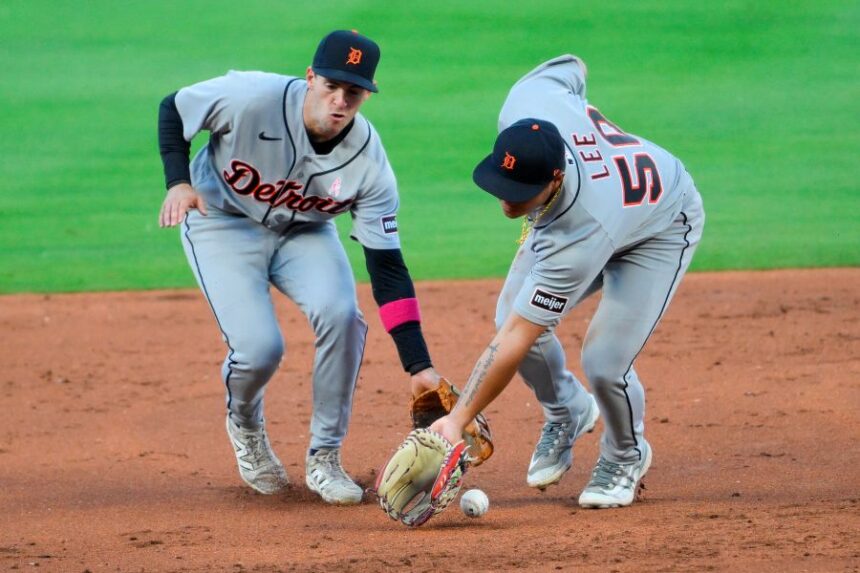 Detroit Tigers second baseman Hao-Yu Lee (50) and shortstop Zach Short, left, cannot make a play on a single hit by Kansas City Royals' Bobby Witt Jr. during the third inning of a baseball game in Kansas City, Mo., Sunday, May 10, 2026. (AP Photo/Reed Hoffmann)