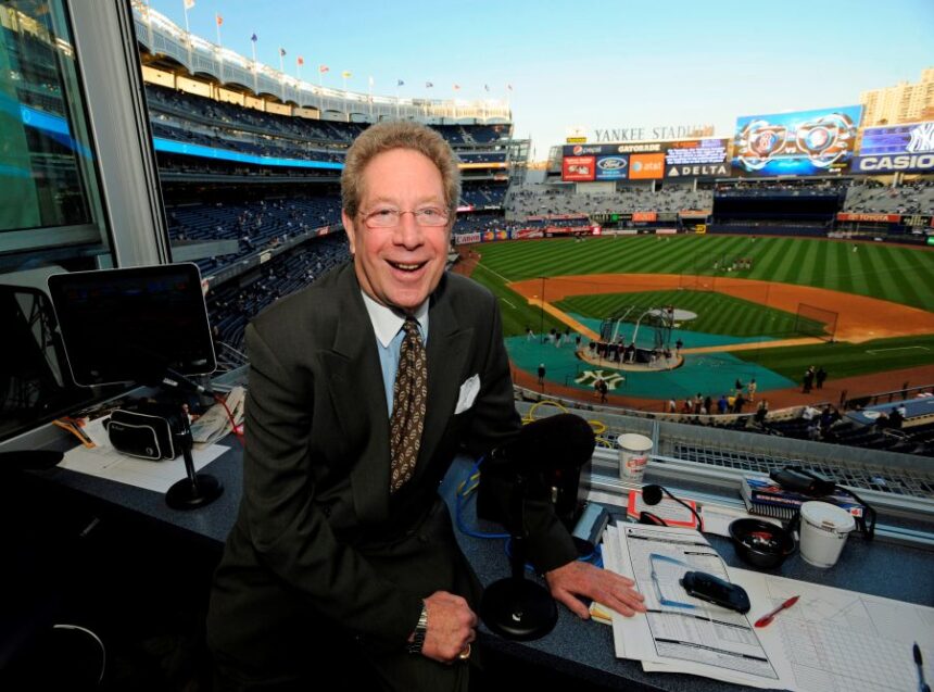FILE - In this Sept. 25, 2009 file photo shows New York Yankees broadcaster John Sterling sitting in his booth before a baseball game against the Boston Red Sox at Yankee Stadium in New York. (AP Photo/Bill Kostroun, file)