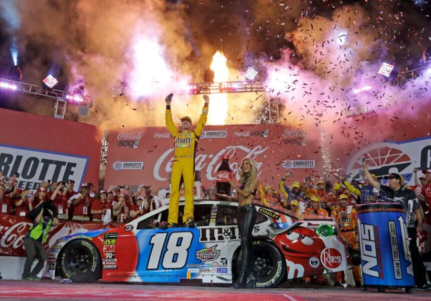 FILE - Kyle Busch celebrates after winning the NASCAR Cup Series auto race at Charlotte Motor Speedway in Charlotte, N.C., Sunday, May 27, 2018. (AP Photo/Chuck Burton, File)