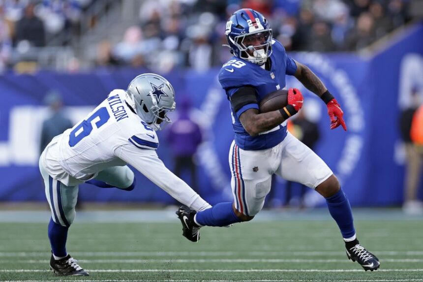 FILE - New York Giants running back Tyrone Tracy Jr. (29) runs with the ball past Dallas Cowboys safety Donovan Wilson (6) during an NFL football game on Jan. 4, 2026, in East Rutherford, N.J. (AP Photo/Adam Hunger, File)