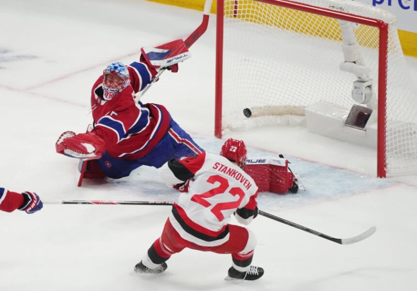 Carolina Hurricanes' Logan Stankoven (22) scores on Montreal Canadiens goaltender Jakub Dobes (75) during the first period of Game 4 of NHL Eastern Conference final Stanley Cup playoff series action in Montreal, Quebec, Wednesday, May 27, 2026. (Christinne Muschi/The Canadian Press via AP)