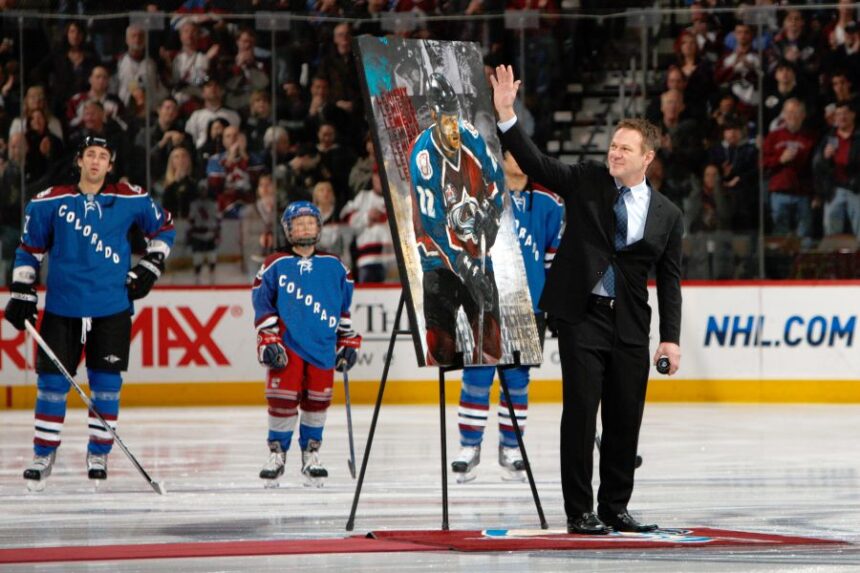 FILE - Retired Colorado Avalanche player Claude Lemieux waves to fans as he is honored for his years on the ice before the Avalanche host the New Jersey Devils in the first period of an NHL hockey game in Denver, Saturday, Jan. 16, 2010. (AP Photo/David Zalubowski, File)