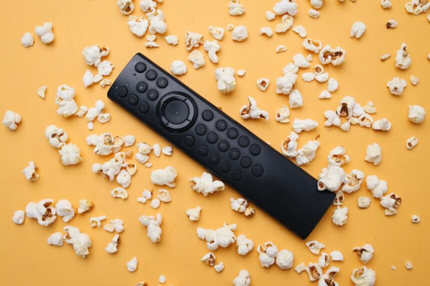 Remote and Popcorn on Yellow Background Still Life