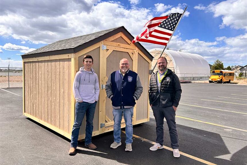 Thunder Ridge High School students Austin Prince, left, with Bonneville Technical Careers High School Principal Lindon Oswald, center, and construction teacher Kyle Wright, in front of a shed that students built for veterans. | Rett Nelson, EastIdahoNews.com