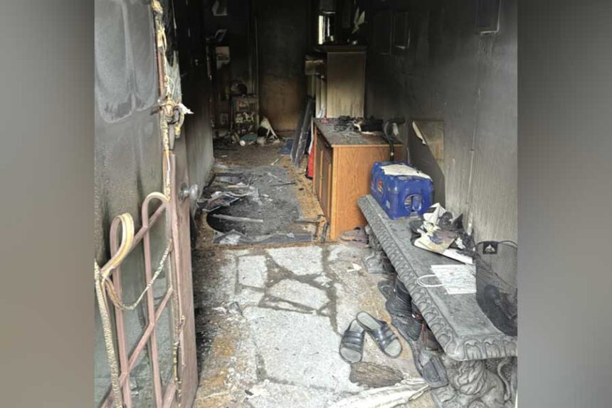 After the fire, looking in through the front door of the home where Scot Sorenson initially attempted to enter to rescue Sonya Noles. The stairs are around the corner to the left.\