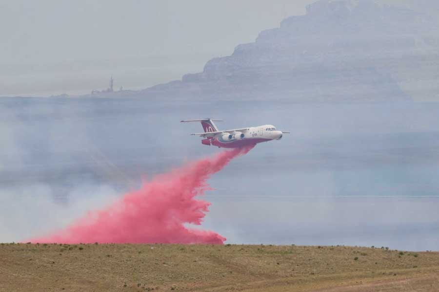 An air tanker drops fire retardant on the Michaud Creek Fire, burning on the Fort Hall Indian Reservation south of Interstate 86 and about 10 miles west of Pocatello, on Saturday, June 6, 2026.