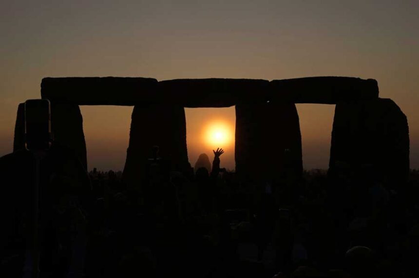 Revelers gather at the ancient stone circle Stonehenge to celebrate the Summer Solstice, the longest day of the year, near Salisbury, England, Wednesday, June 21, 2023.