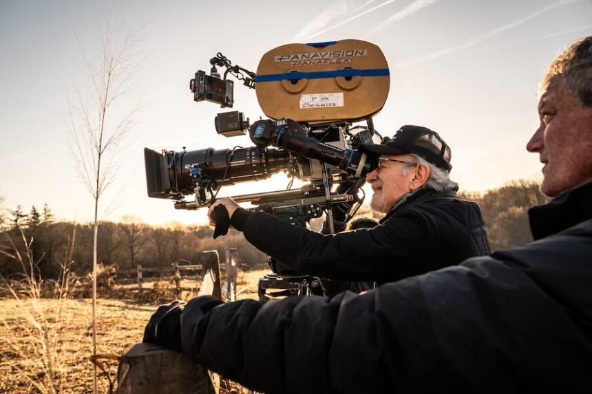 This image released by Universal Pictures shows director Steven Spielberg, center, on the set of "Disclosure Day."