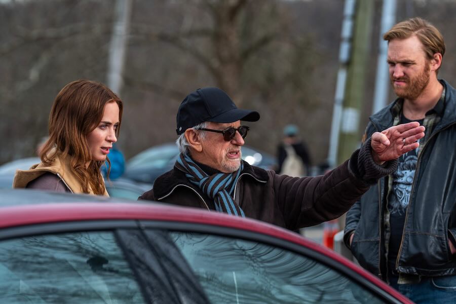 This image released by Universal Pictures shows director Steven Spielberg, center, with actors Emily Blunt, left, and Wyatt Russell on the set of "Disclosure Day."