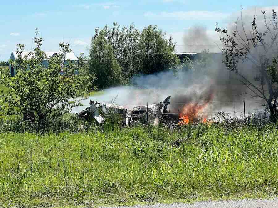The wreckage of a plane crash burns in a field in Butler, Mo, Sunday, June 14, 2026.