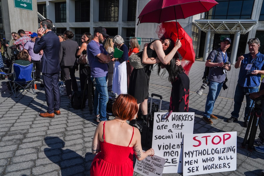 Members of a sex-workers rights group, hug each other while waiting in line to enter the Arthur M. Cromarty Criminal Court Complex ahead of a court sentencing for convicted murderer, Rex Heuermann, Wednesday, June 17, 2026, in Suffolk County, New York.