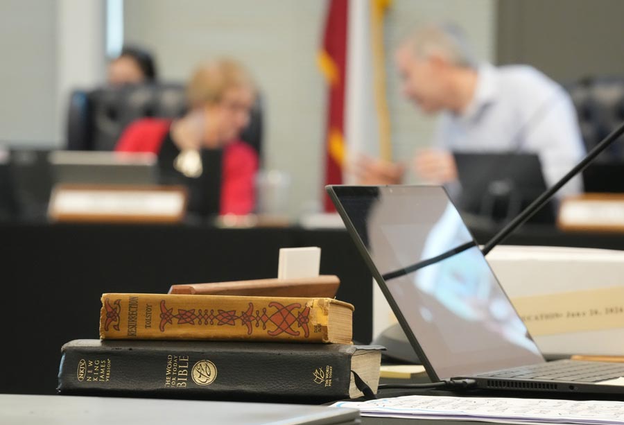A Bible and Resurrection by Leo Tolstoy sit on the desk of State Board of Education member LJ Francis during a meeting on proposed social studies standards at the Barbara Jordan Building in Austin on Monday, June 22, 2026. | Jay Janner, Austin American-Statesman via Associated Press
