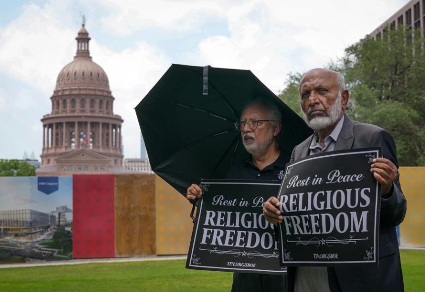 Mohammed Nasrullah, left, and Aziz Soomro, both of Houston, participate in an interfaith funeral-themed protest outside the Barbara Jordan Building in Austin on Monday, June 22, 2026. | Jay Janner, Austin American-Statesman via Associated Press