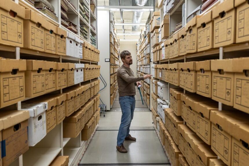 Idaho State Historical Society Reference Archivist Owen Prout walks through the agency’s vault of historical records on May 21, 2026. (Photo by Kyle Pfannenstiel/Idaho Capital Sun)