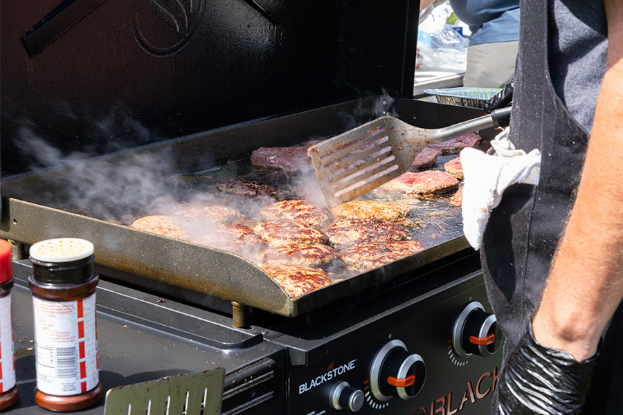 Burgers are grilled at the Smith Group's annual Family Fun Fest. | Courtesy of the Smith Group