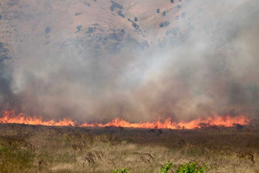 A wildfire burns near the 6000 Block of W. Old Highway 91 in Bannock County on Sunday, June 21, 2026.