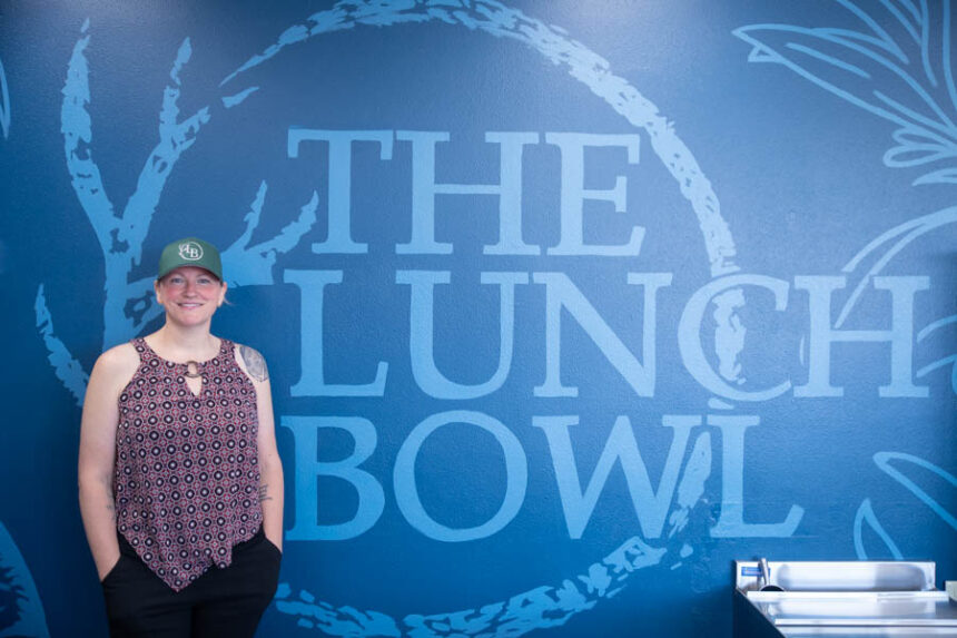 Keri Kimbrough stands next to a sign for the Lunch Bowl. | Cody Roberts, EastIdahoNews.com
