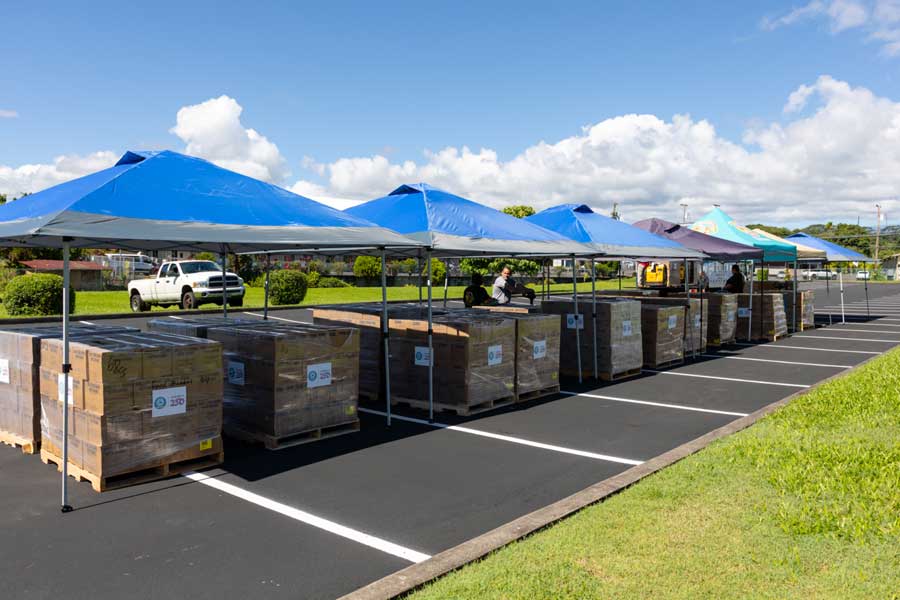 At a Church meetinghouse parking lot in Hilo, Hawaii, on June 13, 2026, nonprofit representatives, members, and friends of The Church of Jesus Christ of Latter-day Saints meet to organize a food donation from the Church as part of the America250 America Gives initiative. Hawaii is the 50th state to receive a donation.