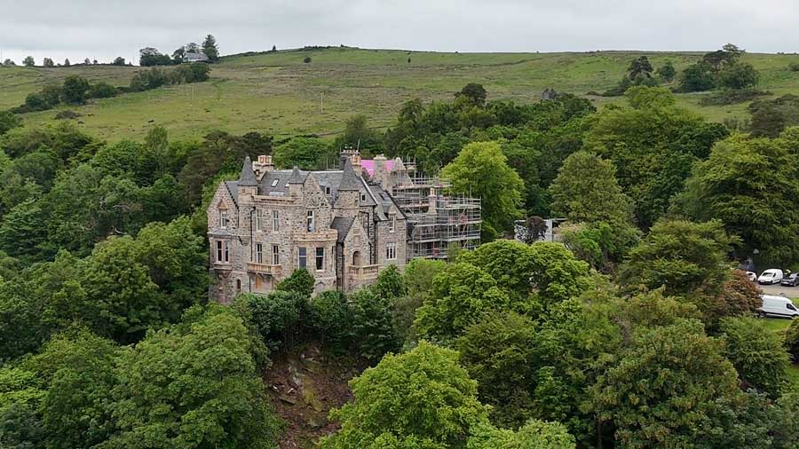 A distant view of the exterior of a Utah couple's castle in Cove, Scotland, as it undergoes renovations in 2026.