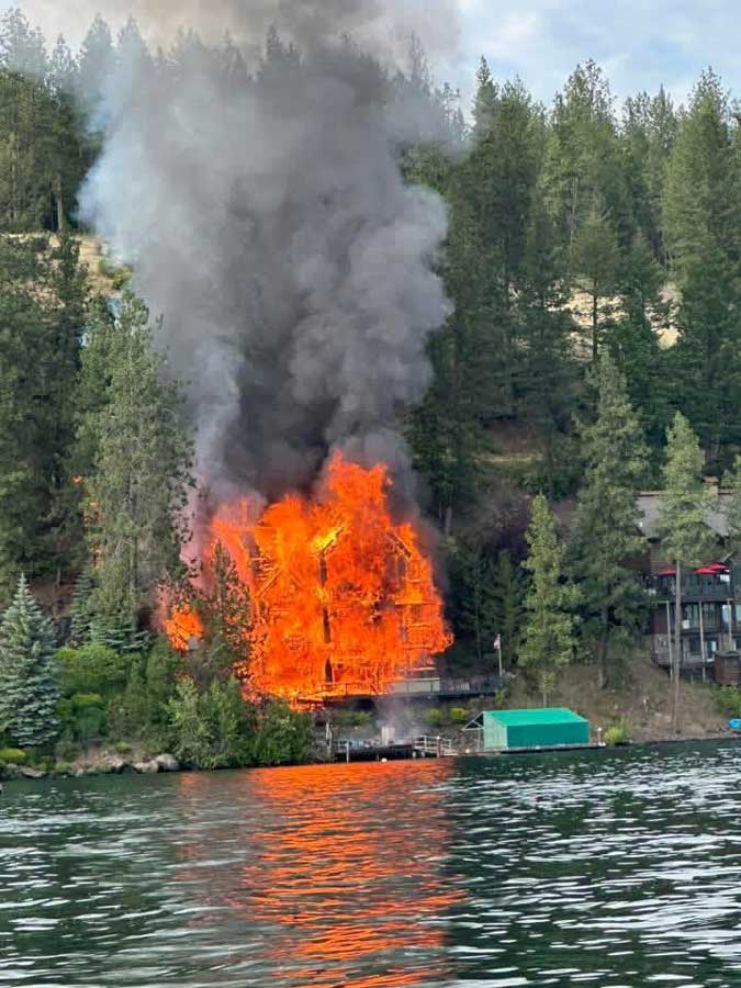 Firefighters from Northern Lakes Fire Protection District work to extinguish a massive house fire at Hayden Lake, in Kootenai County, on Friday, June 19, 2026.