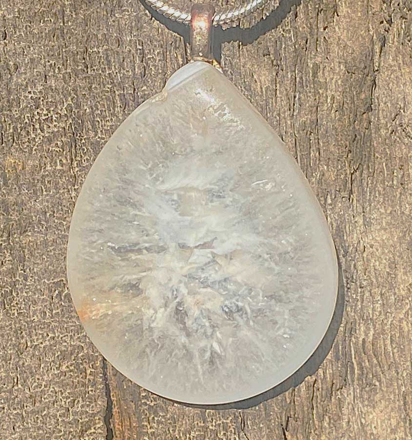A necklace made out of an agate nodule containing crushed quartz crystals in it.